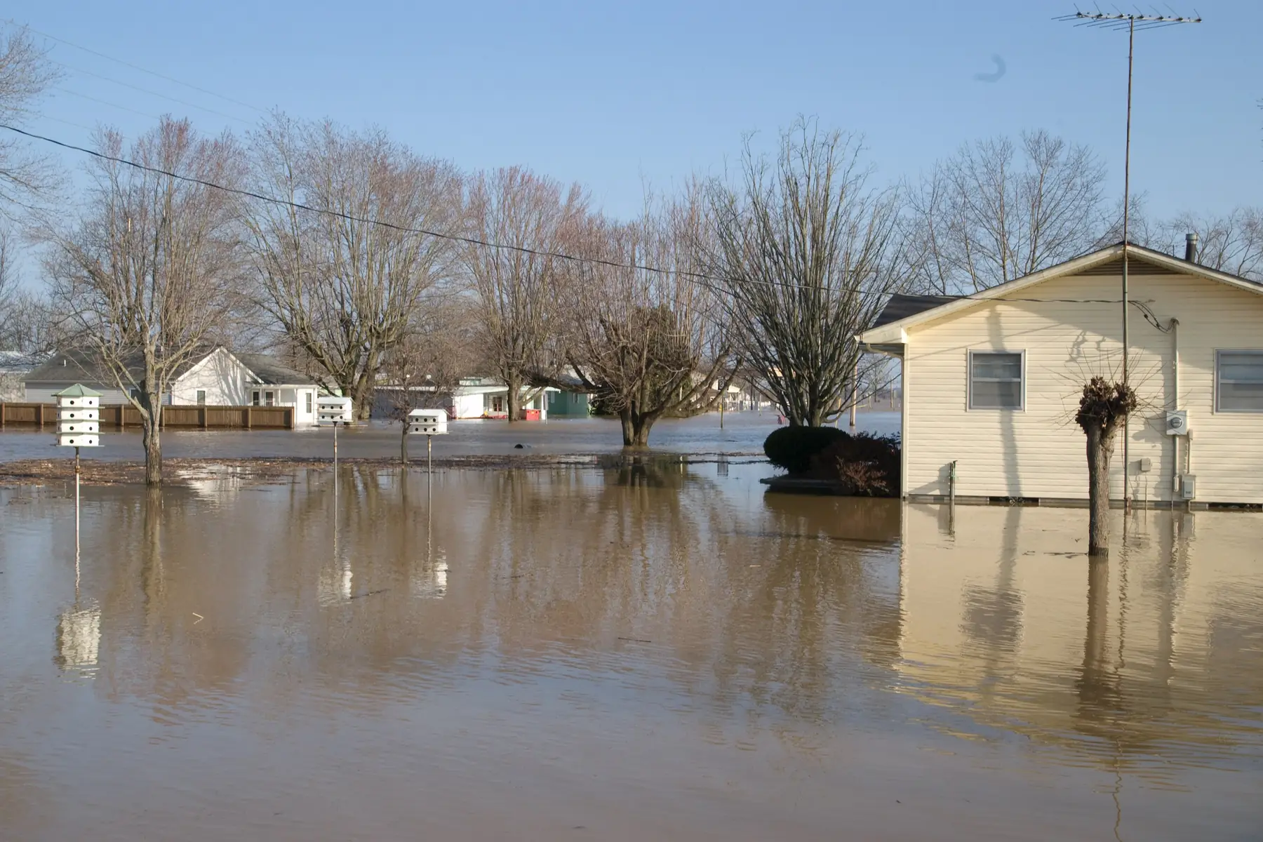 Floodwater surrounding homes in a rural Missouri neighborhood